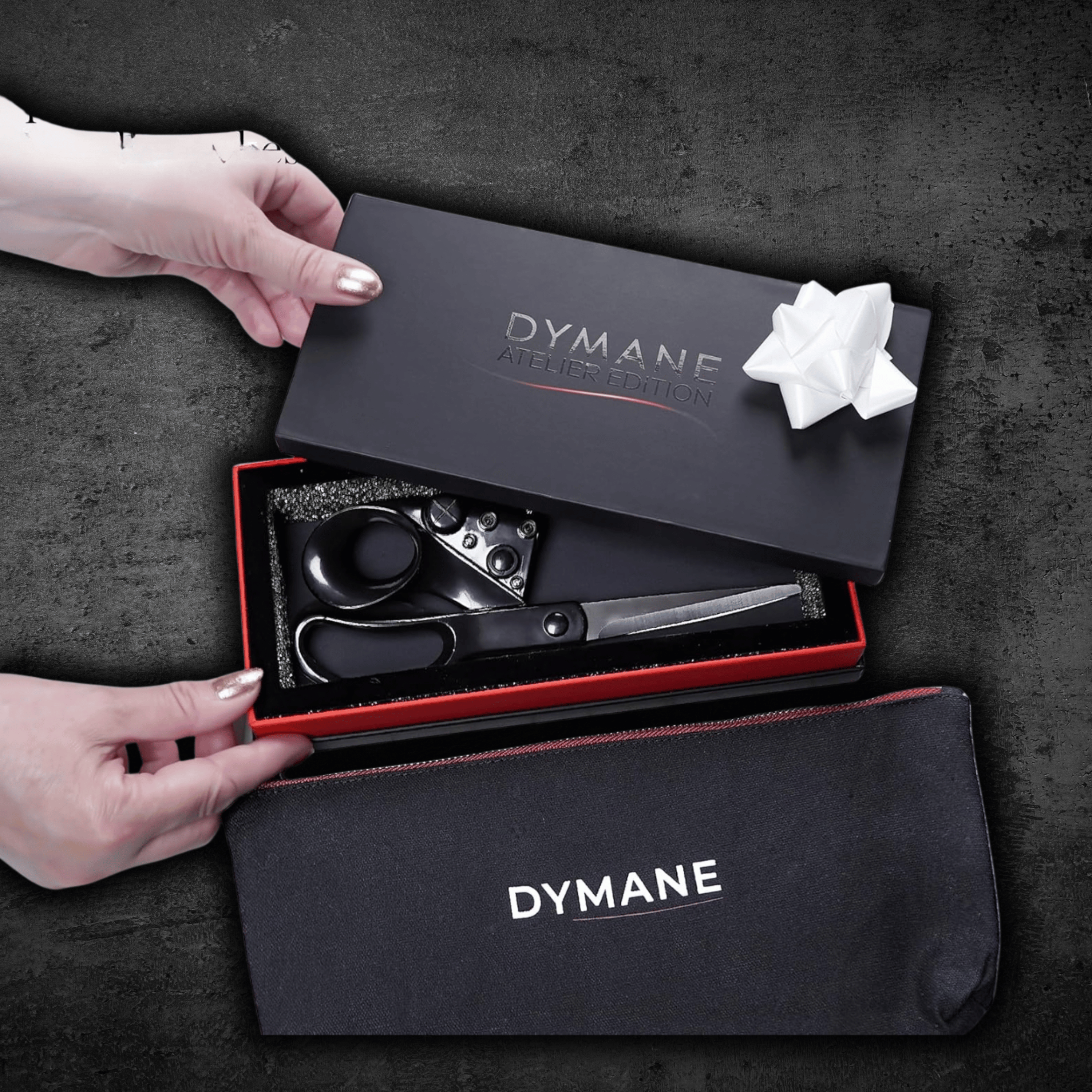 Opening the Dymane gift box with scissors and matching pouch